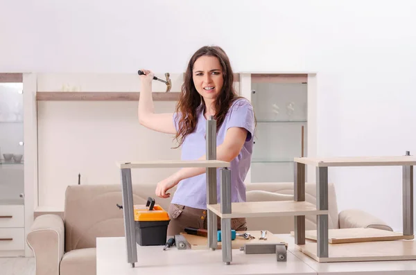 Ung kvinna reparera stol hemma — Stockfoto