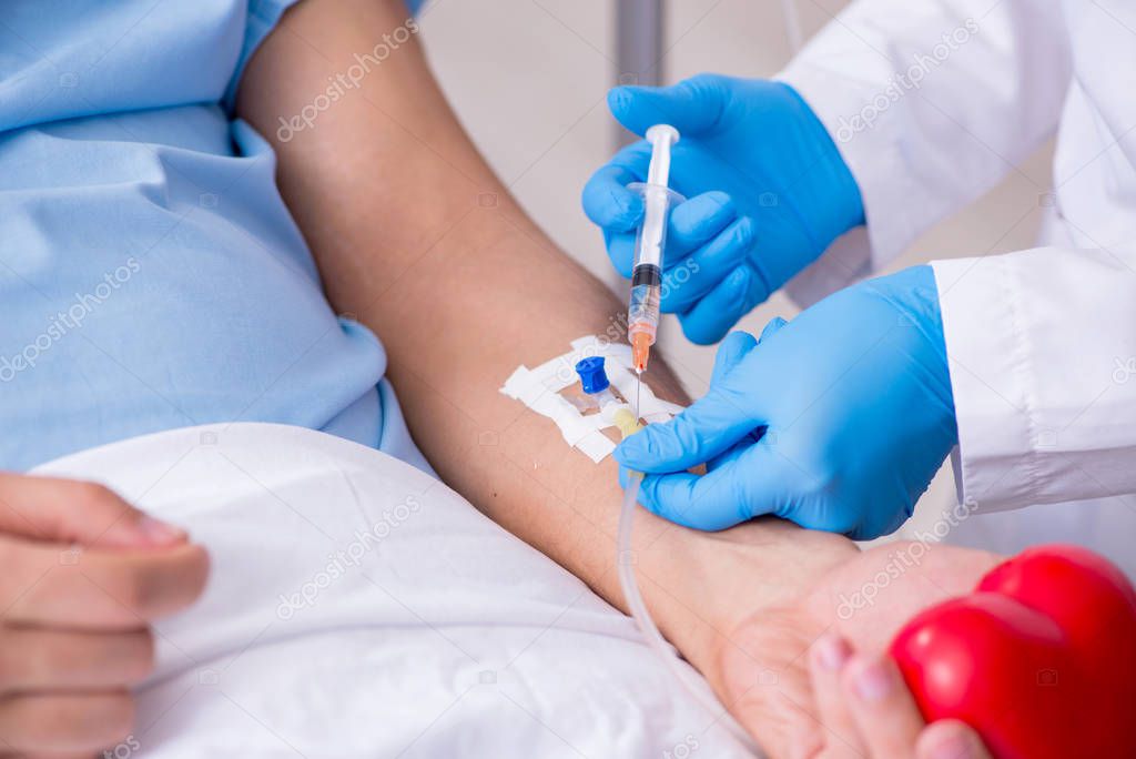 Male patient getting blood transfusion in hospital clinic