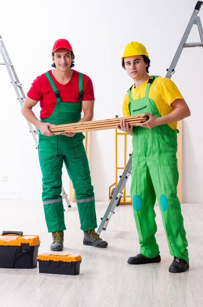 Two workers contractors working indoors