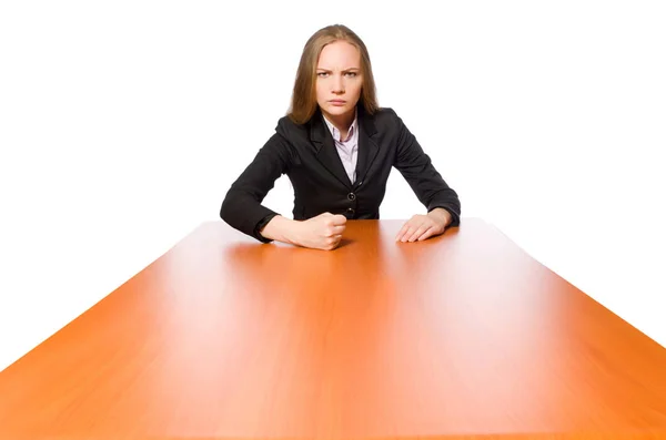 Empleada sentada en mesa larga aislada en blanco — Foto de Stock