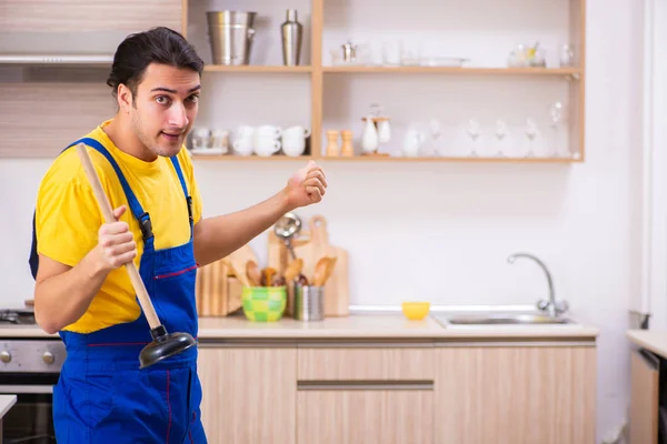 Młody mężczyzna wykonawca naprawy kranu w domu — Zdjęcie stockowe