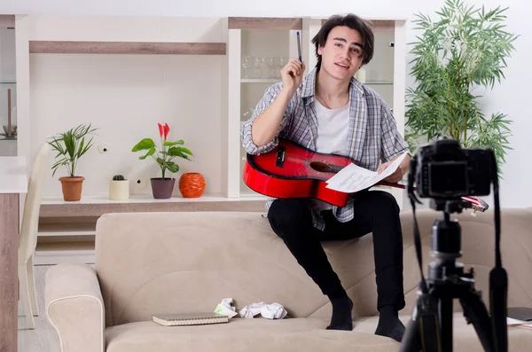 Young guitar player recording video for his blog — Stock Photo, Image