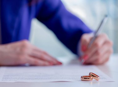 Woman signing prenuptial agreement in court clipart