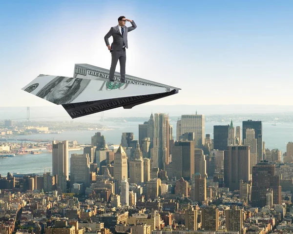 Empresario volando en avión de papel en concepto de negocio — Foto de Stock