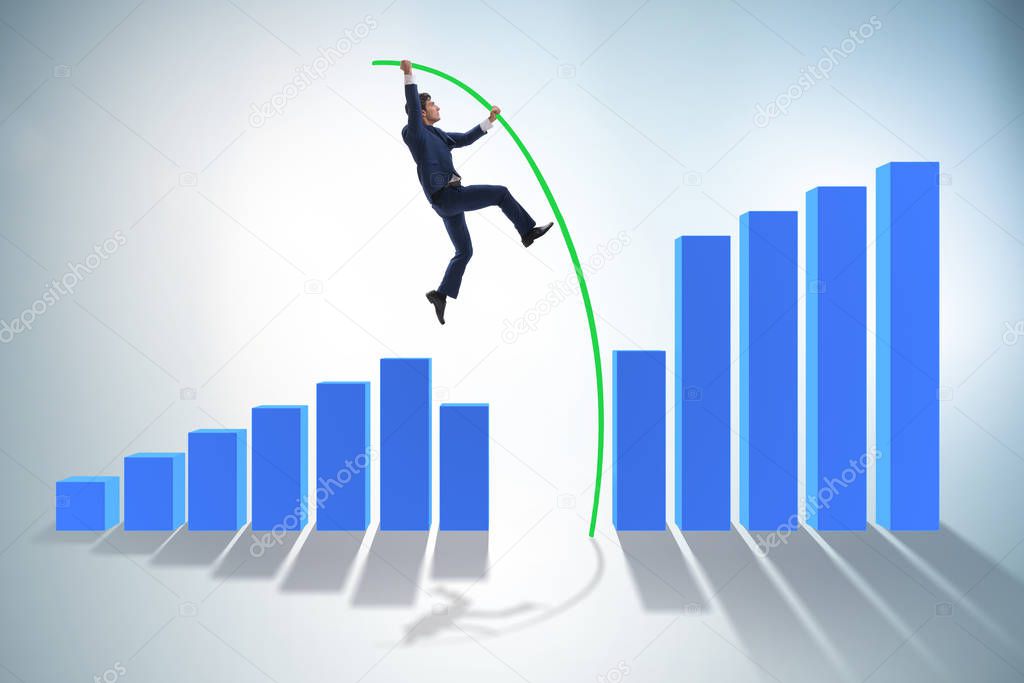 Businessman vault jumping over bar charts