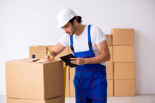 Young male professional mover doing home relocation