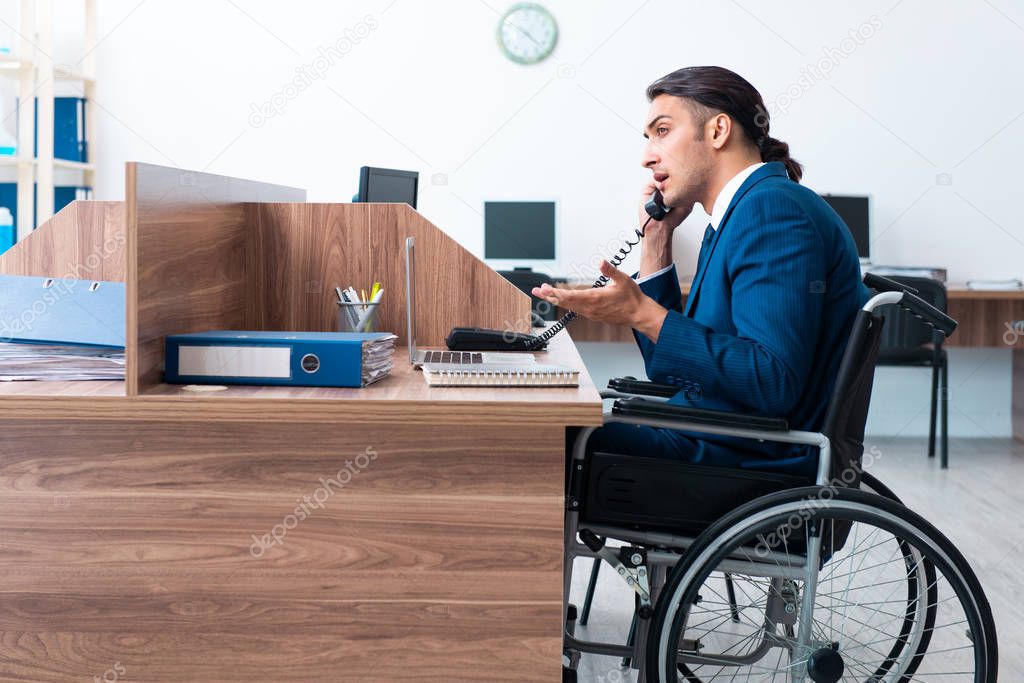 Young male employee in wheel-chair