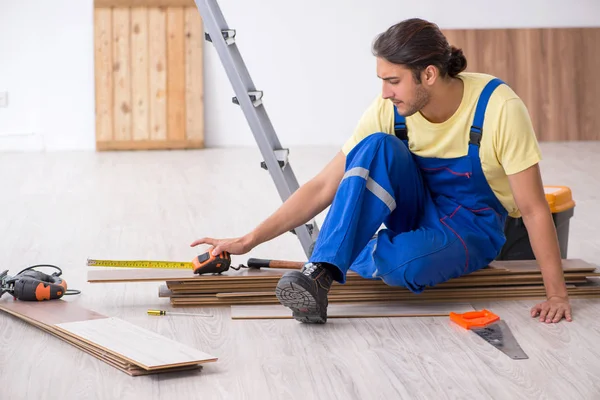 Young male contractor working indoors