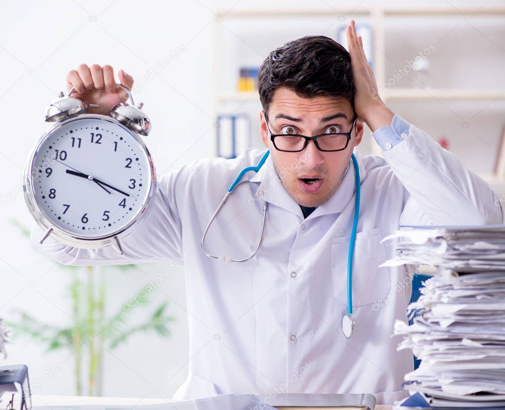 Doctor with alarm clock in urgent check-up concept