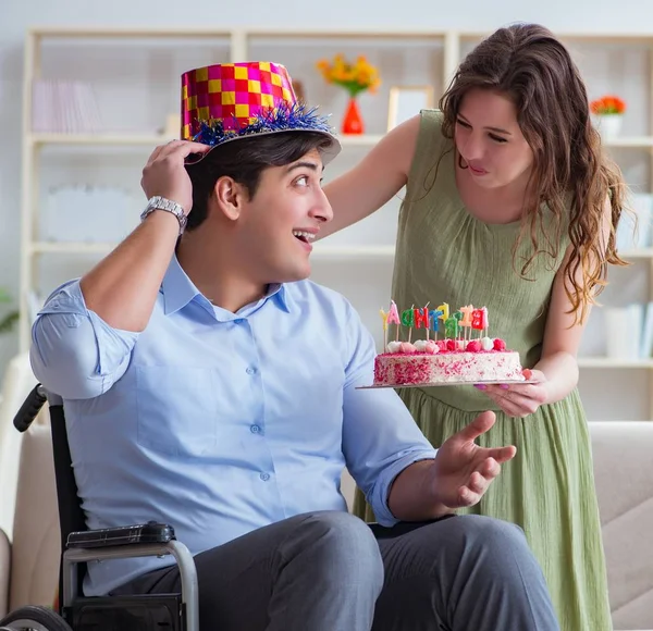 The young family celebrating birthday with disabled person — Stock Photo, Image