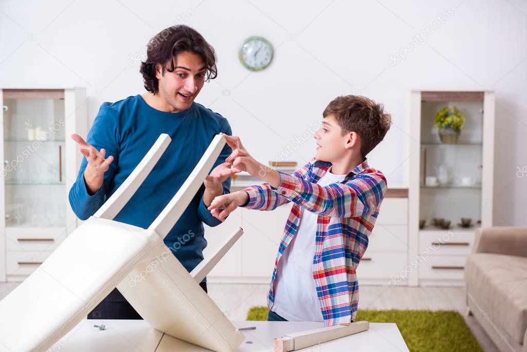 Young carpenter teaching his son