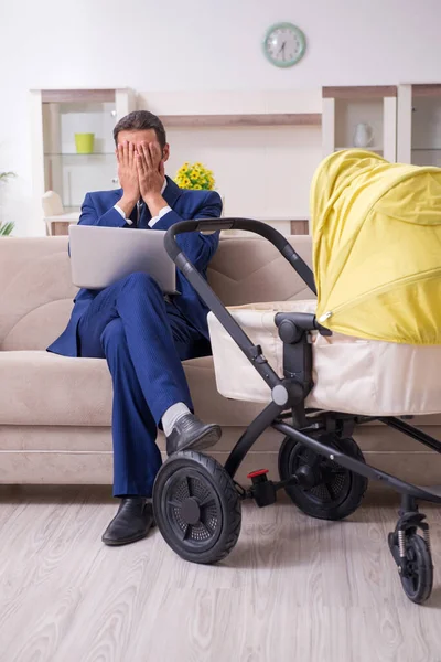 Young businessman looking after baby — Stock Photo, Image