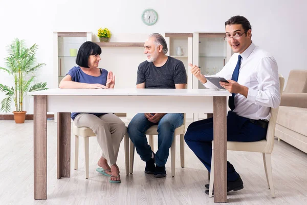 Financial advisor giving retirement advice to old couple
