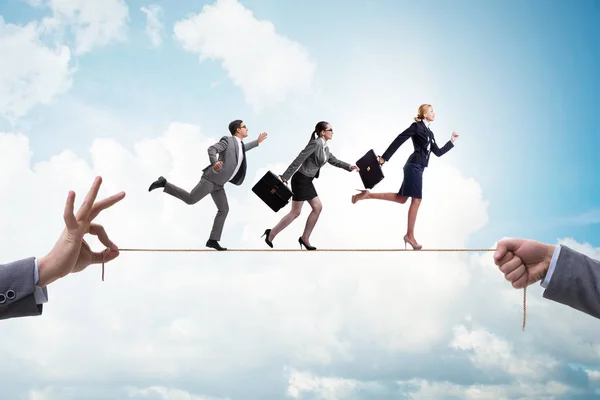 Business people walking on tight rope — Stock Photo, Image