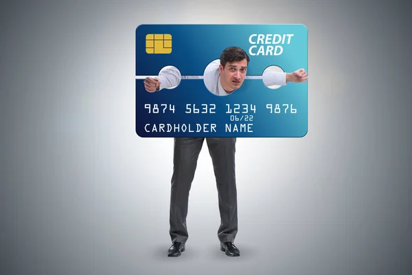 Businessman in credit card burden concept in pillory