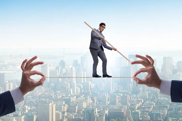 Businessman walking on tight rope — Stock Photo, Image