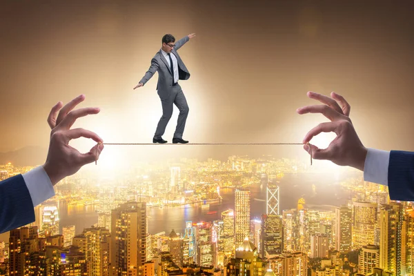 Businessman walking on tight rope — Stock Photo, Image