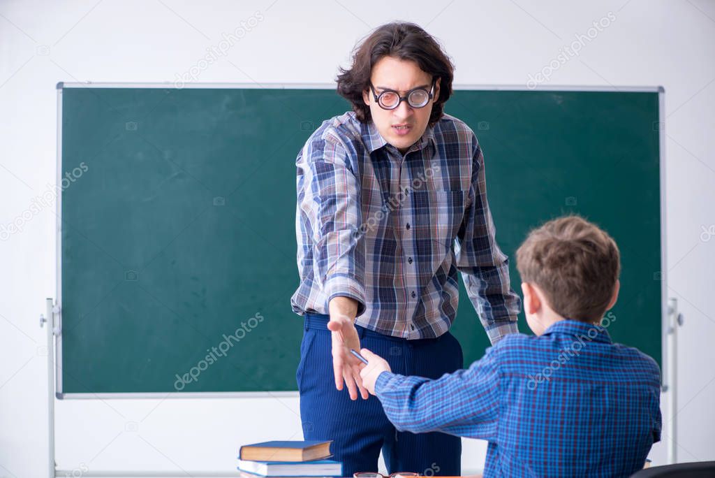 Funny male teacher and boy in the classroom
