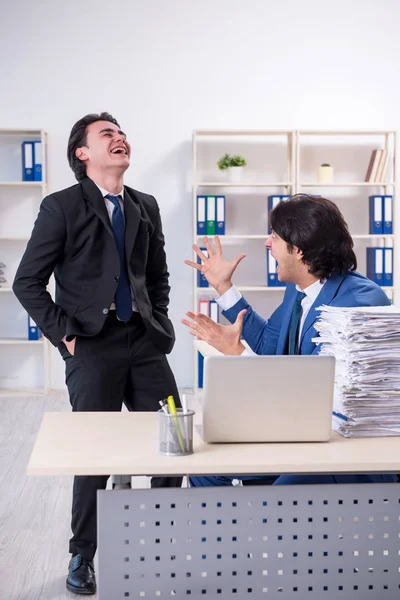 Two male colleagues unhappy with excessive work — Stock Photo, Image