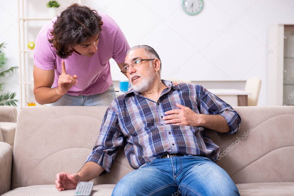 Young student and his old grandpa at home