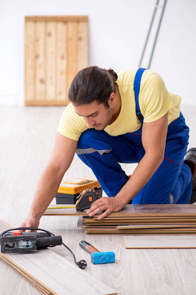 Young male contractor working indoors