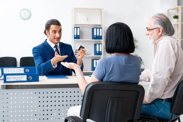 Financial advisor giving retirement advice to old couple — ストック写真