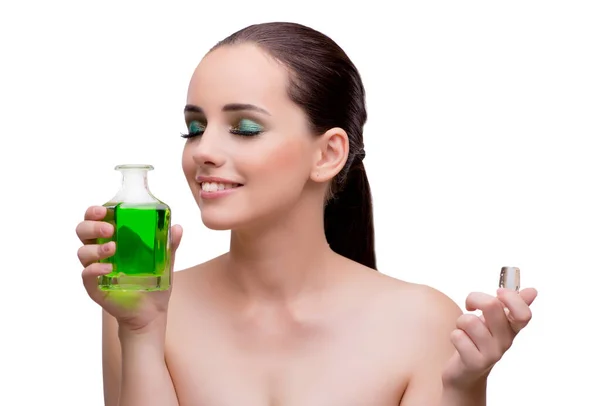 Woman holding a bottle of green perfume — Stock Photo, Image