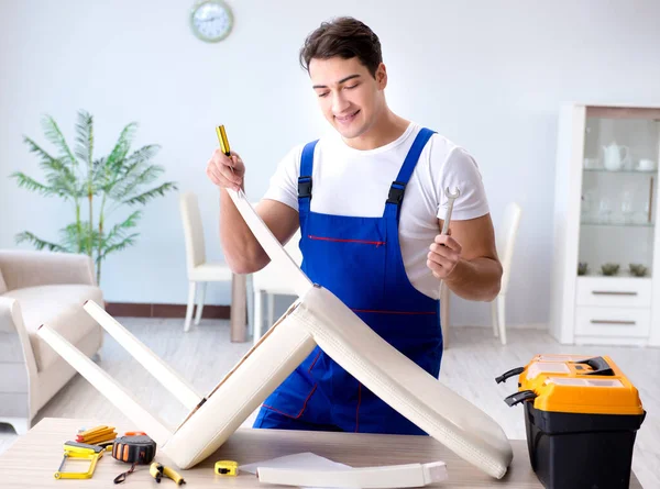Mann repariert Stuhl im Zimmer — Stockfoto