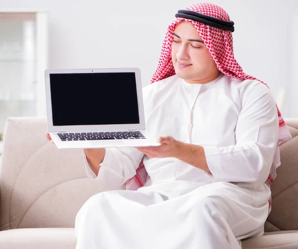 Young arab businessman working with laptop on sofa — Stock Photo, Image