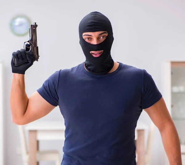 Robber wearing balaclava stealing valuable things — Stock Photo, Image