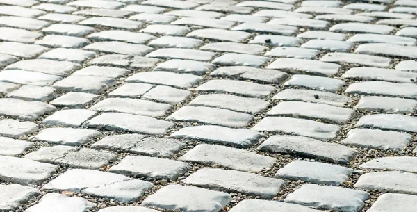 Straße gepflastert mit Pflastersteinen für den Hintergrund — Stockfoto