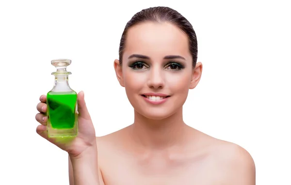 Woman holding a bottle of green perfume — Stock Photo, Image