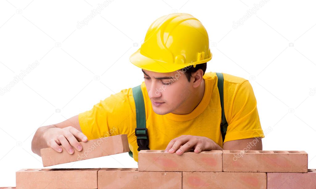 Handsome construction worker building brick wall