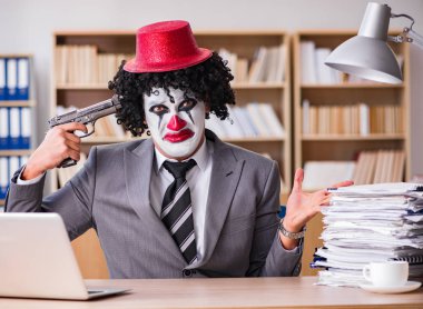 Ofiste çalışan palyaço işadamı.