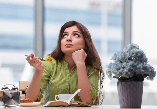 Young girl having breakfast at home