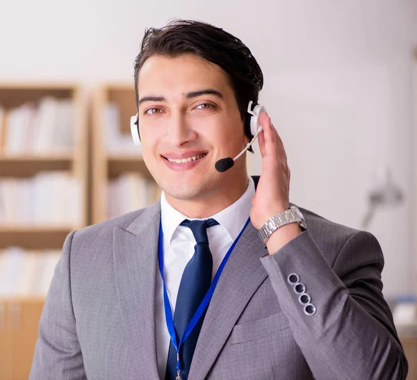 Handsome customer service clerk with headset — Stock Photo, Image