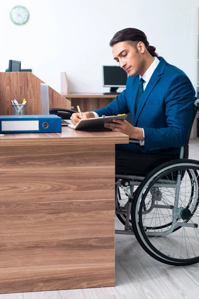 Young male employee in wheel-chair — Stock Photo, Image