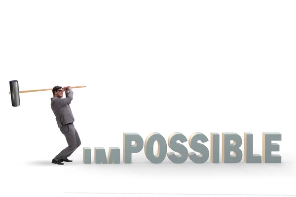 Businessman hitting the word impossible with hammer — ストック写真