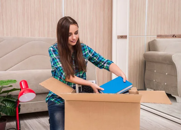 Young woman packing personal belongings