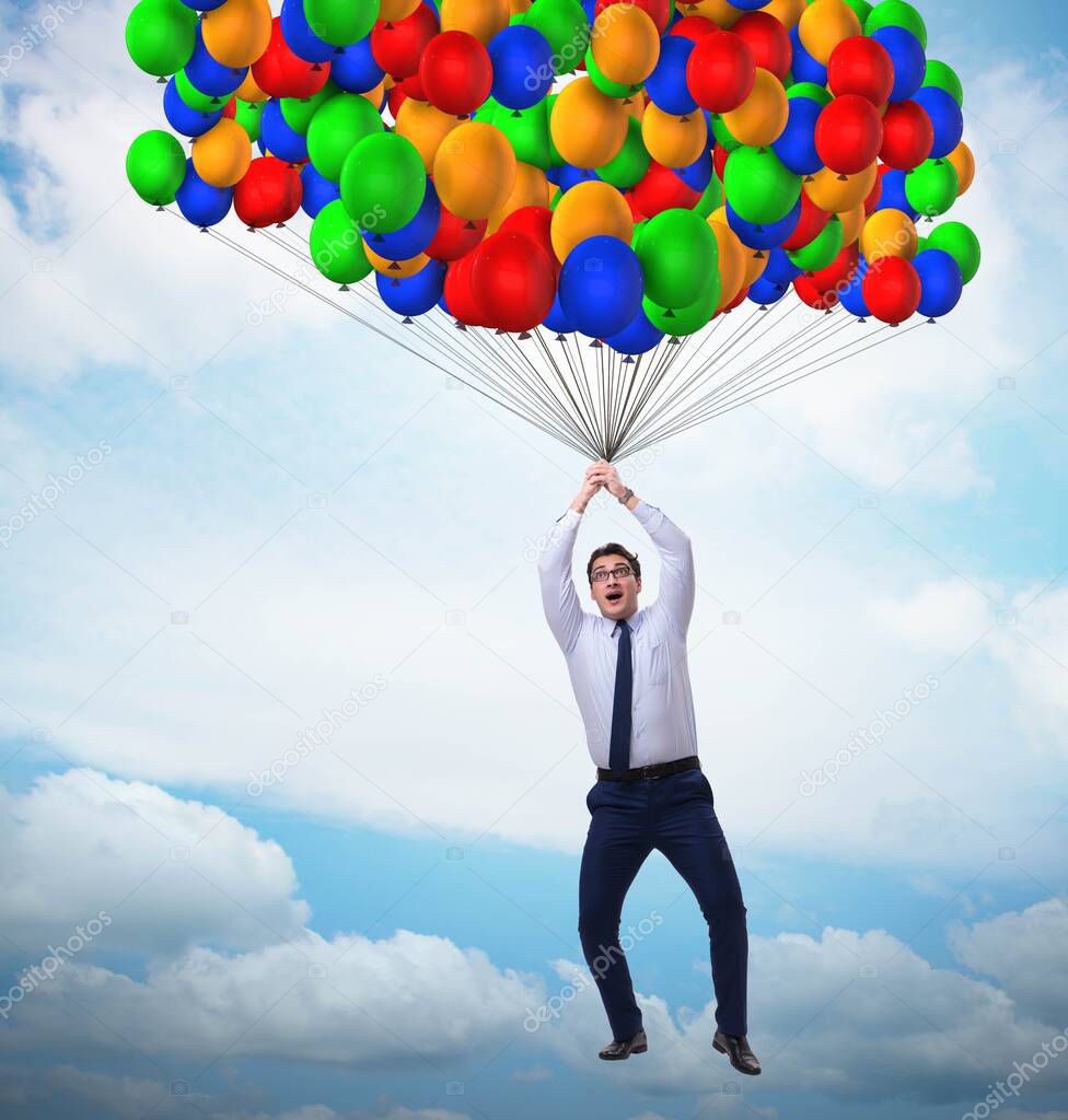 Businessman flying on balloons in challenge concept