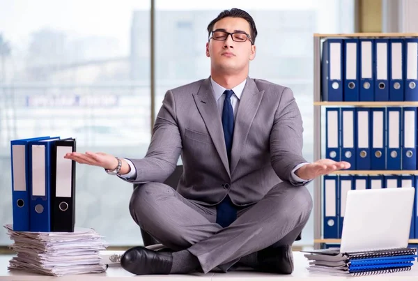 Businessman meditating in the office — Stock Photo, Image