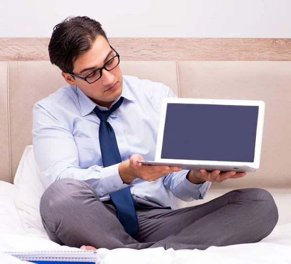 Businessman working in the bed at home — Stock Photo, Image