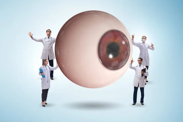 Médecin examinant oeil géant dans le concept médical — Photo