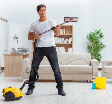 Koca adam evi temizliyor, karısına yardım ediyor.