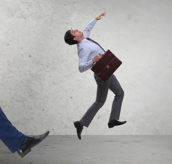 Bad angry boss kicking employee in business concept — Stock Photo, Image