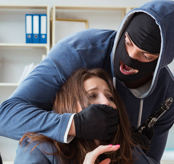 Criminal taking businesswoman as hostage in office