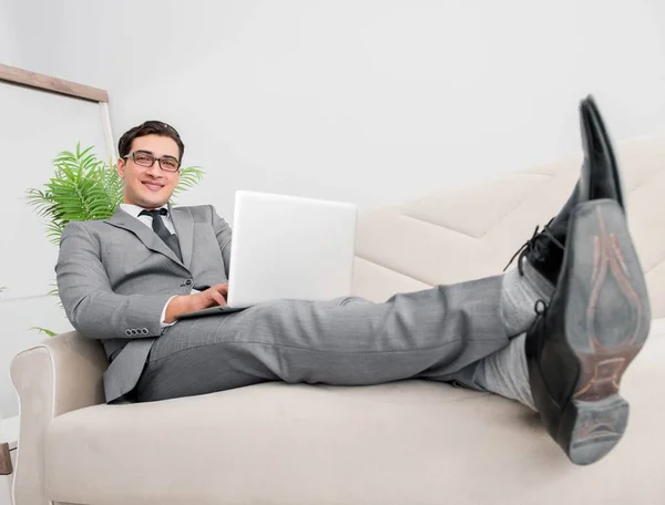 Young businessman lying on the sofa — Stock Photo, Image