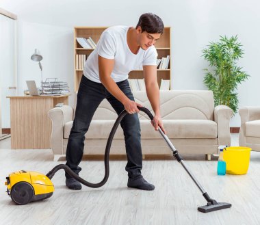 Koca adam evi temizliyor, karısına yardım ediyor.