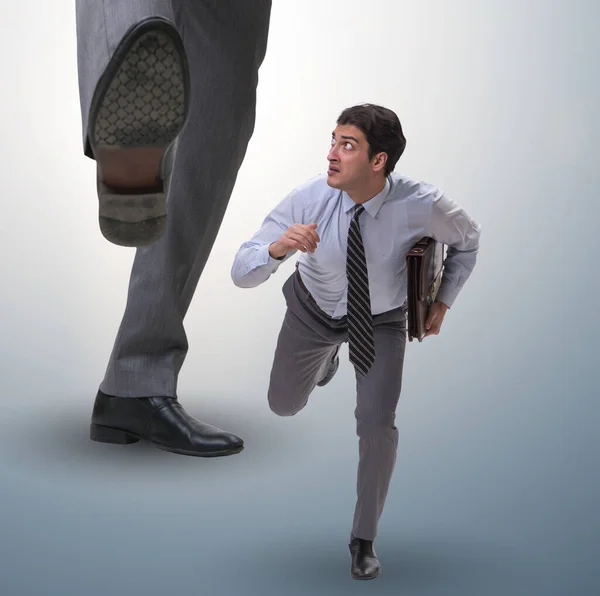 Bad angry boss kicking employee in business concept — Stock Photo, Image