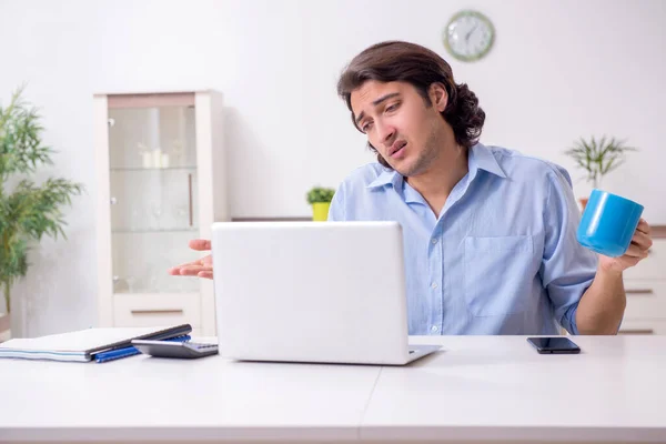 Young male employee working at home — Stock Photo, Image